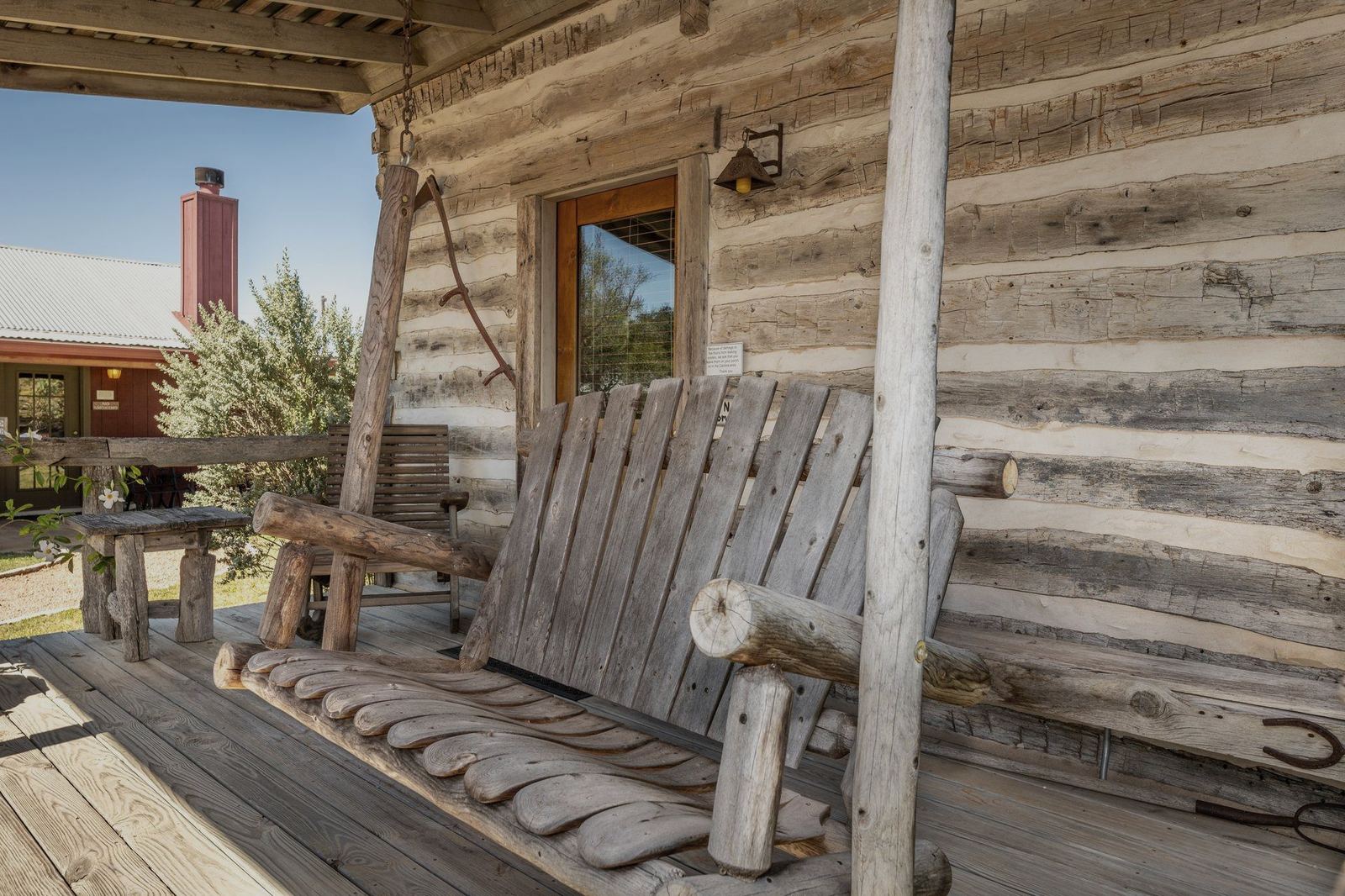 Porch swing on a log cabin at Chuckwagon Inn
